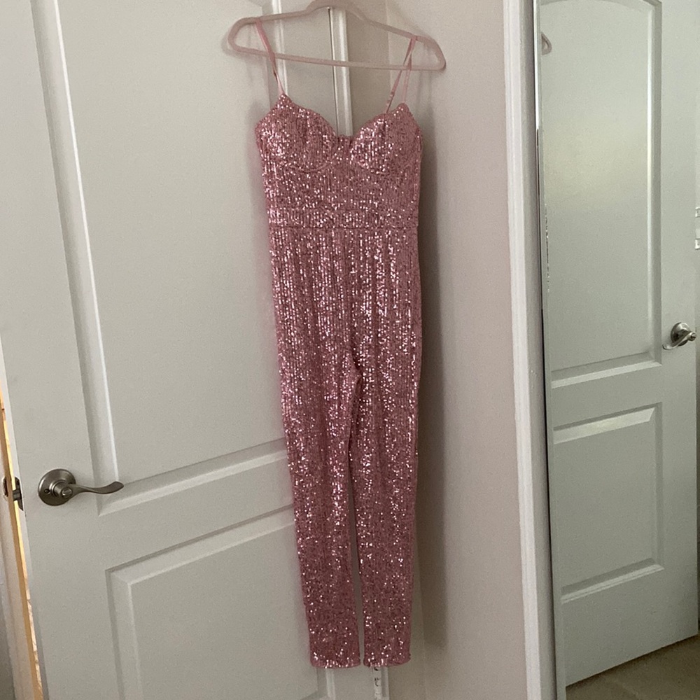 Pink sequin fashion nova jumpsuit never worn. Still has the tag. Size L